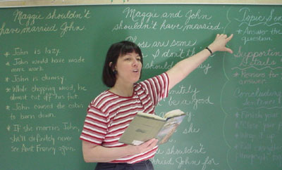 photo of author and teacher Marcy Canterna discussing a book with students in her fourth grade classroom at Franklin Regional school district. Children books, teacher guides guides, schooling, learning.